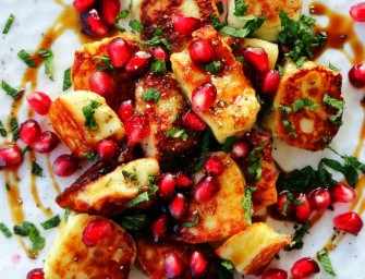 Grilled halloumi cheese with pomegranate arils and syrup