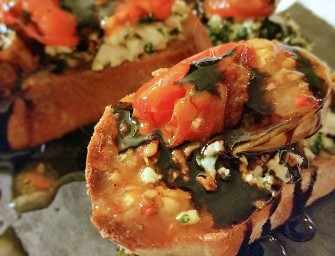Roasted tomatoes and <br>herbed feta crostini