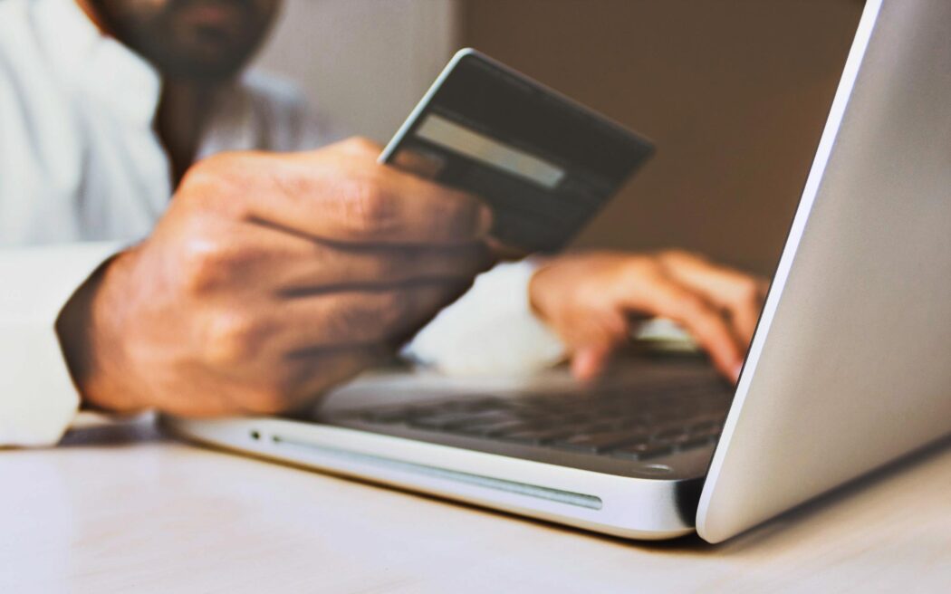 person-using-a-credit-card–unsplash-2048